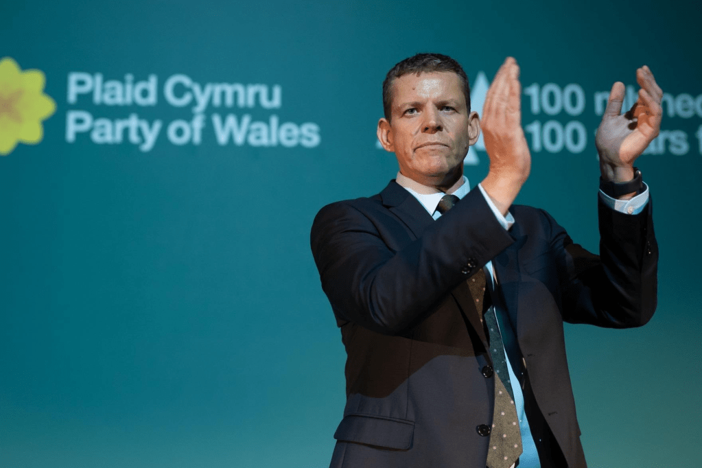 Photo of Rhun ap Iorwerth, a white man in a suit.